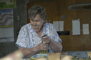 Hibbard Farm: portrait of a woman bunching asparagus, possibly Enid (Mrs. Wallace) Hibbard