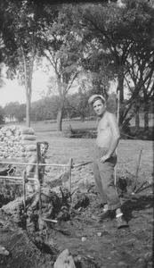 Richard M. Brown and unknown man at barbecue pit, summer session barbecue