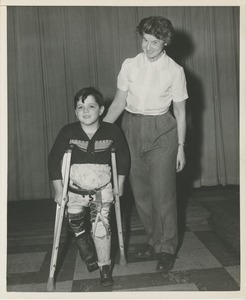 Boy walking on crutches during physical rehabilitation