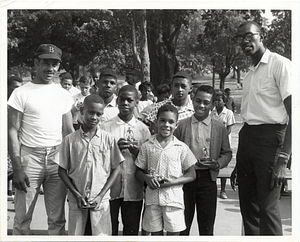 Thomas "Satch" Sanders of the Boston Celtics with an unidentified man and boys