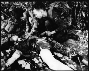 Two soldiers tend a wounded comrade