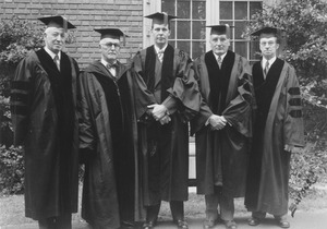 Five men in academic robes in between commencement exercises