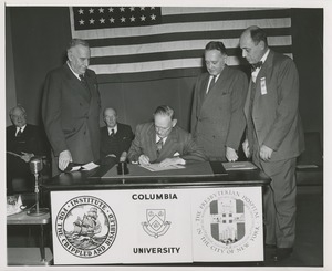 Charles P. Cooper, president of Presbyterian Hospital, signing affiliation agreement