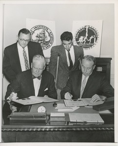 Presidents Bruce Barton of ICD and Carroll V. Newsom of NYU signing an affiliation agreement