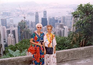 A Photograph of Marlow Monique Dickson and a Friend Posing in front of a City Skyline