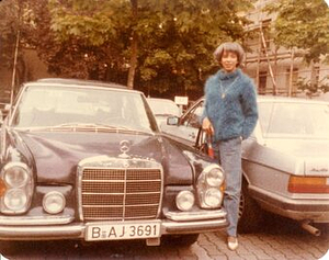A Photograph of Marlow Monique Dickson Standing Next to a Car