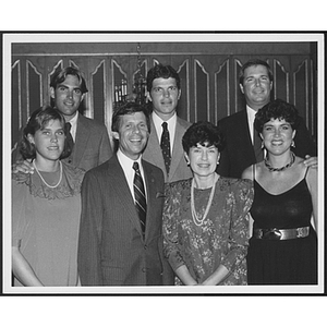 Group of men and women posing together at a formal event