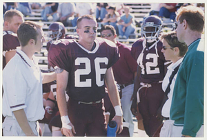 Athletic Trainer checking on a football player