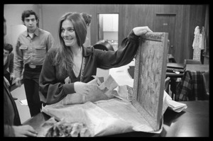 Judy Collins unwrapping a painting