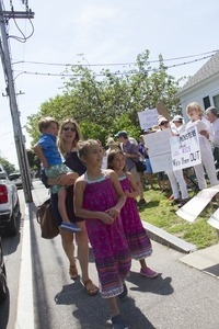 Mother and children walk past Pro-immigration rally outside the Chatham town office building : taken at the 'Families Belong Together' protest against the Trump administration's immigration policies