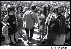 Resistance on the Boston Common: antiwar crowd with Resistance women in foreground wearing dresses with peace symbol and omega patterns