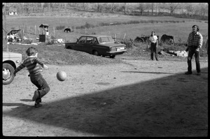 Eben Light kicking a ball by the barn with Tony Mathews, Montague Farm Commune