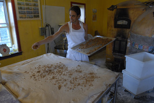 Hungry Ghost Bread: owner and baker Jonathan C. Stevens spreading filling dough for cinnamon rolls