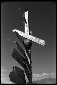 Signpost erected by activists at Nevada Test Site peace encampment reading 'Nuremberg actions, Concord, CA'