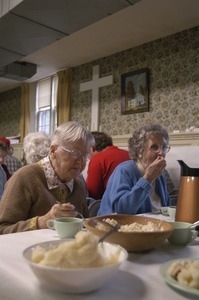 Church supper at the First Congregational Church, Whately: women seated at a table, eating supper