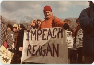 Protester holding 'Impeach Reagan' sign