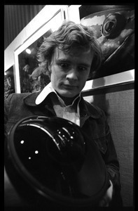 Jeff Albertson, holding a fish-eye lens at a photographic exhibition (possibly of work by David Doubilet)