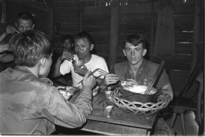 Lt. Tolley and Lt. Chau having lunch in farmer's home; Tay Ninh.