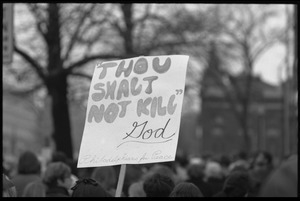 Sign reading 'Thou shalt not ill ---God,' rising above the crowd of marchers at the Counter-inaugural demonstrations, 1969