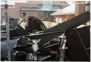The dismantled parts to the back room of Munson Annex are piled up by the quonset hut