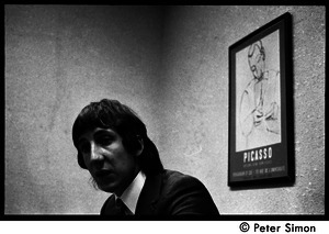 Pete Townshend: seated at a table for an interview (three-quarter profile)