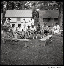 Camp Arcadia: campers and parents seated in front of the cabins