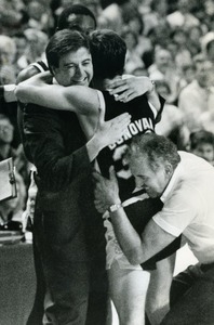 Providence College basketball player Billy Donovan hugs coach Rick Pitino after Providence College v. Georgetown NCAA tournament game