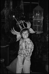 Child making a silly face, wearing a winged No Nukes headdress, Montague Farm commune