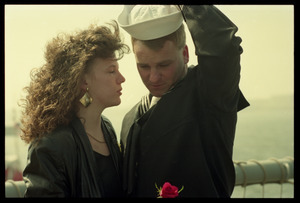 Woman with a rose greeting a sailor from the USS Roberts returning from Persian Gulf War duty