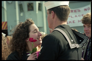 Woman with a rose greeting a sailor from the USS Roberts returning from Persian Gulf War duty
