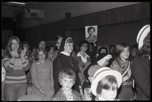 Ellen McCormack, speaking at a campaign rally while running for President: crowd applauding McCormack, with priest and nun in front row
