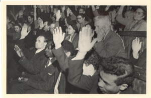 Audience members raising their hands at unidentified conference in Moscow