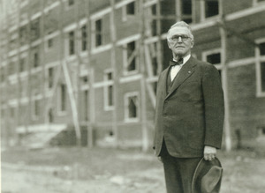 Hugh P. Baker standing in front of building construction