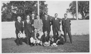 Unidentified male members of the class of 1905 standing and sitting outside