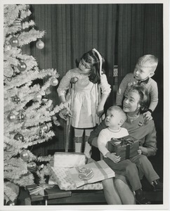 Mrs. Kilbourne and children admiring Christmas tree