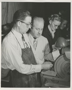 William Murphy working on optical lens grinding equipment