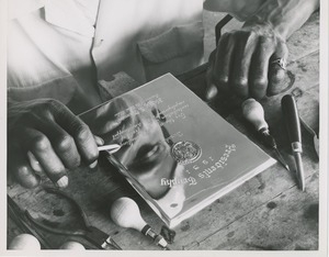 A man works on the 1951 president's trophy