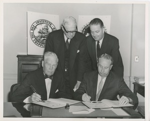 Presidents Bruce Barton of ICD and Carroll V. Newsom of NYU preparing to sign an affiliation agreement