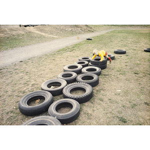 Child playing on tires on a playground