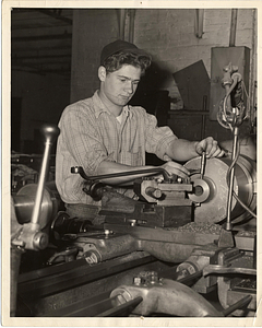 [Student working at a machine]