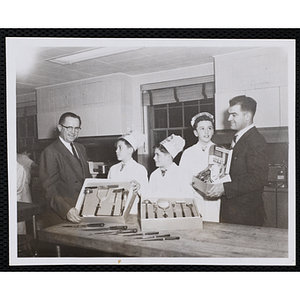 Three members of the Tom Pappas Chefs' Club receive gifts of knives and utensils from the Chefs' Club Advisory Committee's Alex Armour (far left) and Harvard Club Steward Charles Wallace (far right)