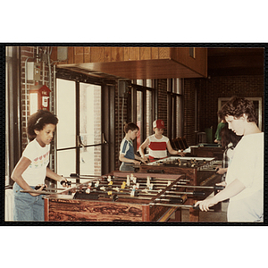 A girl and a boy play foosball