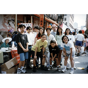 Chinese Progressive Association youth and volunteers pose near the organization's booth in Boston's Chinatown during the August Moon Festival