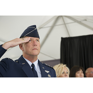 Lieutenant General Ted F. Bowlds salutes during the pledge of allegiance