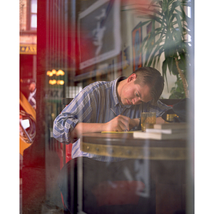 Co-op student seated at table, writing