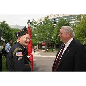 Neal Finnegan and a man converse at the Veterans Memorial groundbreaking ceremony