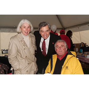 President Freeland poses with two supporters before the Homecoming game