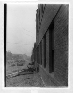 View down the side of the railroad building on Dorchester Ave of construction rubble