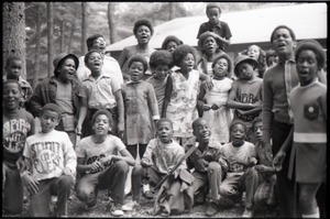 Inner City Round Table of Youth campers: group of African American children at summer camp, some wearing Spirit in Flesh t-shirts, posed in front of camp building
