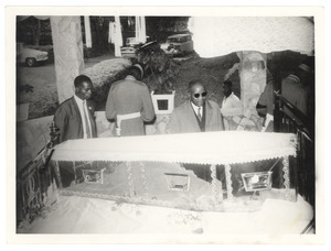 Unidentified man pays his final respects over the casket of W. E. B. Du Bois